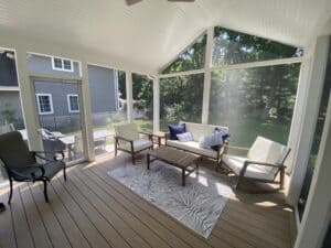 Composite deck & screen porch built in Madison, WI by 3rd Gen Deck Builders featuring a light tan floor & white trim / ceilings.